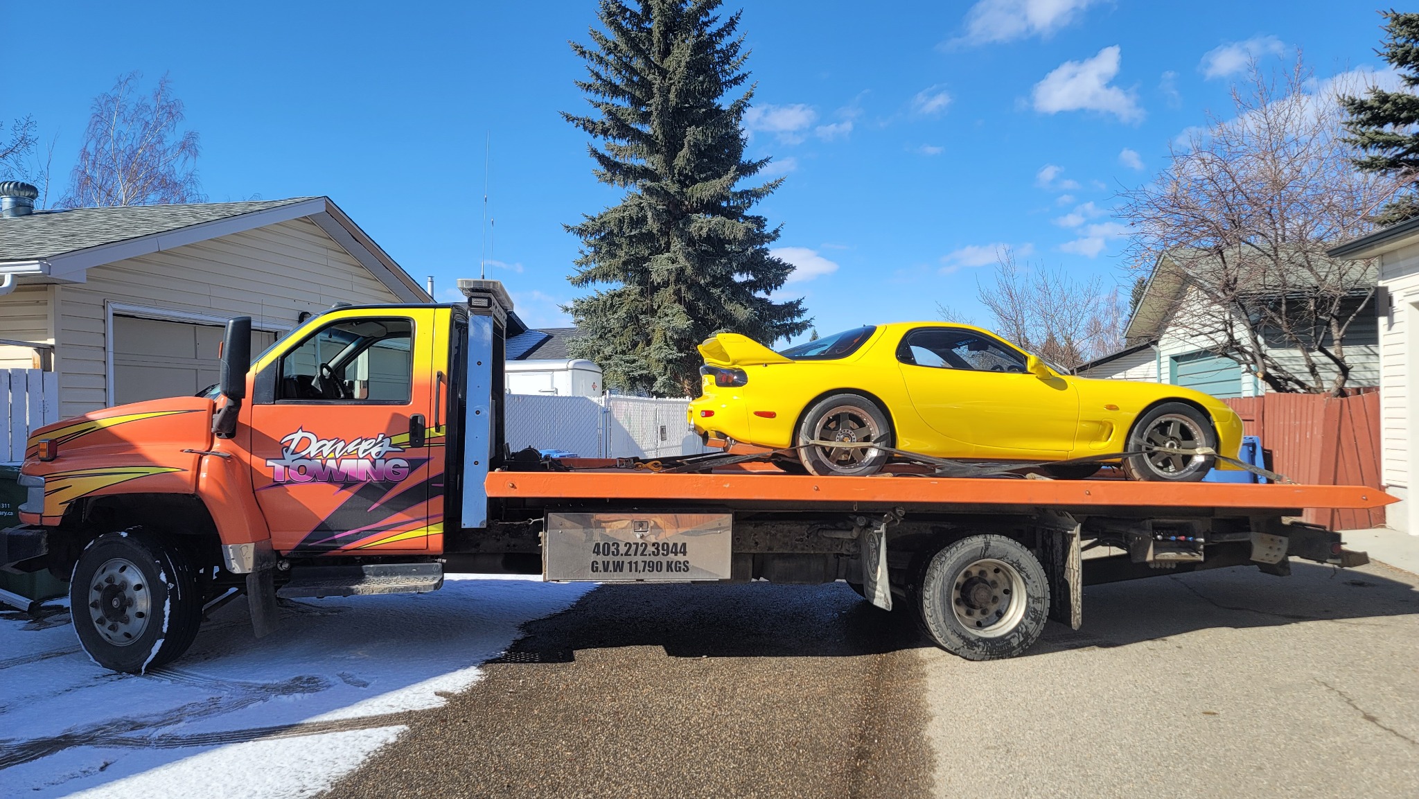 Flatbed towing a sports car